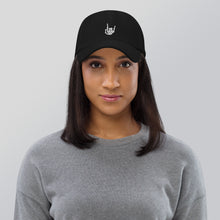 Load image into Gallery viewer, Woman modeling/wearing Black Baseball cap, classic visor shape. Image Design: "Rock On" skeleton hand gesture on the front. Front side view.