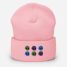 Load image into Gallery viewer, beanie pink, with image design of 6 purple, green, and blue skulls, 2 of each color, in two rows. Front view.