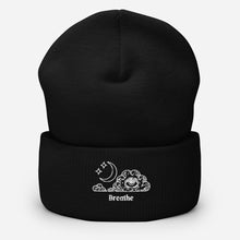 Load image into Gallery viewer, beanie black , with image design of an eye in a cloud, with moon crescent and stars, with the word "Breathe" underneath the image. Front view.