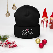 Load image into Gallery viewer, beanie black , with image design of a cartoonish cute skull with heart eyes, a heart bow, and stars. Front view.