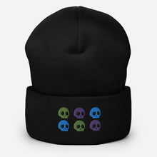 Load image into Gallery viewer, beanie black , with image design of 6 purple, green, and blue skulls, 2 of each color, in two rows. Front view.