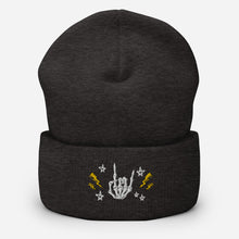 Load image into Gallery viewer, cuffed beanie dark grey, with image design of rock on skeleton hand, pentagram stars, lightning symbols. background: winter themed, Christmas gifts.