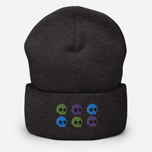 Load image into Gallery viewer, beanie dark grey, with image design of 6 purple, green, and blue skulls, 2 of each color, in two rows. Front view.
