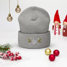 Load image into Gallery viewer, cuffed beanie heather grey, with image design of rock on skeleton hand, pentagram stars, lightning symbols. background: winter themed, Christmas gifts.