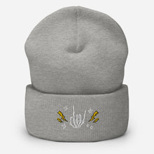 Load image into Gallery viewer, cuffed beanie heather grey, with image design of rock on skeleton hand, pentagram stars, lightning symbols. background: winter themed, Christmas gifts.