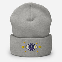 Load image into Gallery viewer, cuffed beanie heather grey, with image design of purple eye of protection/evil eye, with yellow stars. background: winter themed, Christmas gifts.