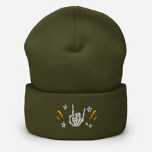 Load image into Gallery viewer, cuffed beanie olive green, with image design of rock on skeleton hand, pentagram stars, lightning symbols. background: winter themed, Christmas gifts.