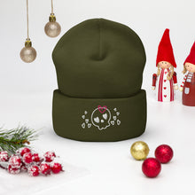 Load image into Gallery viewer, beanie olive green, with image design of a cartoonish cute skull with heart eyes, a heart bow, and stars. Front view.