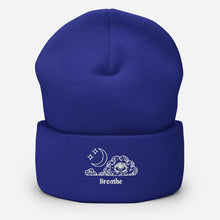 Load image into Gallery viewer, beanie royal blue, with image design of an eye in a cloud, with moon crescent and stars, with the word "Breathe" underneath the image. Front view.