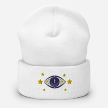 Load image into Gallery viewer, cuffed beanie white, with image design of purple eye of protection/evil eye, with yellow stars. background: winter themed, Christmas gifts.