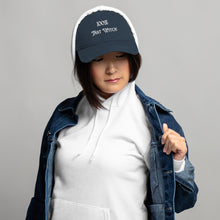 Load image into Gallery viewer, Woman in hoodie modeling/wearing Vintage navy blue distressed hat. Baseball cap. Phrase: 100% That Witch. Featuring bold embroidered white lettering on the front, playful and stylish. Front side center view.