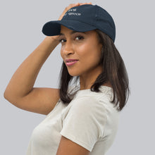 Load image into Gallery viewer, Side view, woman modeling/wearing vintage navy blue distressed hat. Baseball cap. Phrase: 100% That Witch. Featuring bold embroidered white lettering on the front, playful and stylish