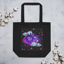 Load image into Gallery viewer, black tote bag, certified organic, cotton, tote bag, dreamy eye with a crescent moon in the iris, surrounded by soft, whimsical clouds, pink and purple stars, orange highlights.