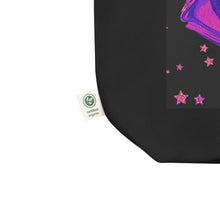 Load image into Gallery viewer, close up image of black tote bag, showing tag certified organic, tote bag, dreamy eye with a crescent moon in the iris, surrounded by soft, whimsical clouds, pink and purple stars, orange highlights.