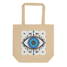 Load image into Gallery viewer, oyster colored tote bag with image of eye of protection/evil eye, colors of golden yellow, blue, light blue, third eye, eye, celestial stars. certified organic, cotton.