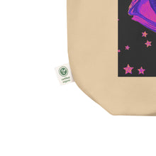 Load image into Gallery viewer, close up image of oyster beige tote bag, showing tag certified organic, tote bag, dreamy eye with a crescent moon in the iris, surrounded by soft, whimsical clouds, pink and purple stars, orange highlights.