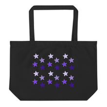 Load image into Gallery viewer, Large black tote bag, certified organic, features rows of purple stars, with each row darker than the one above it, creating a striking gradient effect. 4 shades of purple.