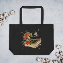 Load image into Gallery viewer, Large black tote bag, cotton, certified organic, with Image Design: Old book, vial, mushroom, and butterfly with a vintage look
