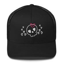 Load image into Gallery viewer, retro trucker hat/cap black, with image design of a cartoonish cute skull with heart eyes, a heart bow, and stars. Front view.