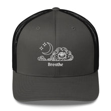 Load image into Gallery viewer, retro trucker hat/cap charcoal grey black, with image design of an eye in a cloud, with moon crescent and stars, with the word "Breathe" underneath the image. Front view.