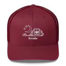Load image into Gallery viewer, retro trucker hat/cap cranberry red, with image design of an eye in a cloud, with moon crescent and stars, with the word "Breathe" underneath the image. Front view.