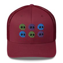 Load image into Gallery viewer, retro trucker hat cranberry red, with image design of 6 purple, green, and blue skulls, 2 of each color, in two rows. Front view.