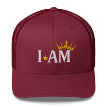 Load image into Gallery viewer, retro trucker hat cranberry red, with image phrase: "I AM," with image graphic of a gold crown over the letter M. Front view.