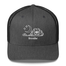 Load image into Gallery viewer, retro trucker hat/cap dark grey heather , with image design of an eye in a cloud, with moon crescent and stars, with the word "Breathe" underneath the image. Front view.