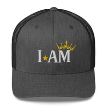 Load image into Gallery viewer, retro trucker hat dark grey heather, with image phrase: "I AM," with image graphic of a gold crown over the letter M. Front view.