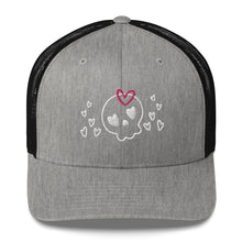 Load image into Gallery viewer, retro trucker hat/cap heather black, with image design of a cartoonish cute skull with heart eyes, a heart bow, and stars. Front view.