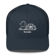 Load image into Gallery viewer, retro trucker hat/cap navy blue , with image design of an eye in a cloud, with moon crescent and stars, with the word "Breathe" underneath the image. Front view.