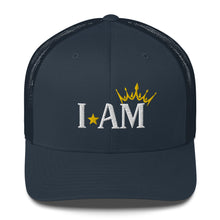 Load image into Gallery viewer, retro trucker hat navy blue, with image phrase: "I AM," with image graphic of a gold crown over the letter M. Front view.