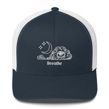 Load image into Gallery viewer, retro trucker hat/cap navy blue white, with image design of an eye in a cloud, with moon crescent and stars, with the word "Breathe" underneath the image. Front view.