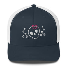 Load image into Gallery viewer, retro trucker hat/cap navy blue white, with image design of a cartoonish cute skull with heart eyes, a heart bow, and stars. Front view.