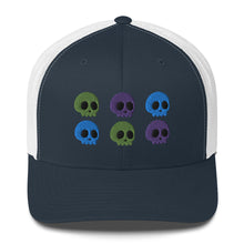 Load image into Gallery viewer, retro trucker hat navy blue white, with image design of 6 purple, green, and blue skulls, 2 of each color, in two rows. Front view.
