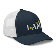 Load image into Gallery viewer, retro trucker hat navy blue white, with image phrase: "I AM," with image graphic of a gold crown over the letter M. side view.
