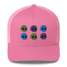 Load image into Gallery viewer, retro trucker hat pink, with image design of 6 purple, green, and blue skulls, 2 of each color, in two rows. Front view.