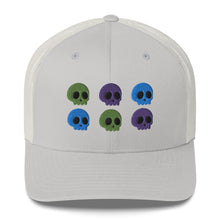 Load image into Gallery viewer, retro trucker hat silver, with image design of 6 purple, green, and blue skulls, 2 of each color, in two rows. Front view.