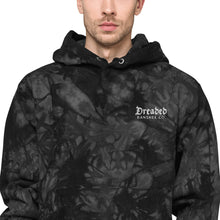 Load image into Gallery viewer, Man modeling/wearing dark grey and black, unisex champion tie-dye hoodie, with pockets. Embroidered logo of "Dreaded Banshee Co." on left hand breast side. Front view. Close up.