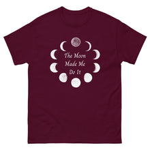 Load image into Gallery viewer, unisex maroon t-shirt with image phrase: The moon made me do it. Bordered with Moon phases. Front view. Halloween, spooky season.