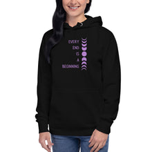 Load image into Gallery viewer, Woman modeling/wearing Black unisex hoodie, with pockets, with image phrase: "Every end is a beginning." with image of moon phases, from new moon, to full moon, back to new moon. Front view.
