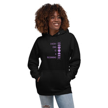 Load image into Gallery viewer, Woman modeling/wearing black unisex hoodie, with pockets, with image phrase: "Every end is a beginning." with image of moon phases, from new moon, to full moon, back to new moon. Front view.