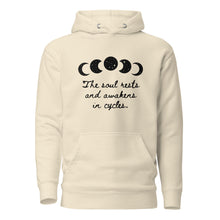 Load image into Gallery viewer, unisex bone cream white hoodie with image phrase "The soul rests and awakens in cycles." With image graphic of silhouette moon phases with star cut outs. Front view.