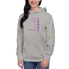 Load image into Gallery viewer, Woman modeling/wearing carbon grey unisex hoodie, with pockets, with image phrase: "Every end is a beginning." with image of moon phases, from new moon, to full moon, back to new moon. Front view.