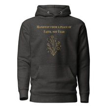 Load image into Gallery viewer, charcoal grey heather unisex hoodie, with pockets, with image phrase: "manifest from a place of faith, not fear." with image graphic of flowers, moon, stardust. Front view.