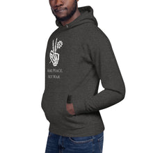 Load image into Gallery viewer, man modeling/wearing charcoal grey heather unisex hoodie, with pockets, with image phrase "Make peace, not war." with image graphic of a skeleton hand holding a daisy flower, and gesturing the peace sign. Front view.