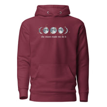 Load image into Gallery viewer, unisex maroon hoodie with image phrase "The moon made me do it." With image graphic of watercolor moon phases, decorated with random gold star constellations. Front view.