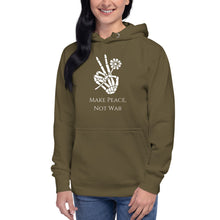 Load image into Gallery viewer, Woman modeling/wearing military army green unisex hoodie, with pockets, with image phrase "Make peace, not war." with image graphic of a skeleton hand holding a daisy flower, and gesturing the peace sign. Front view.