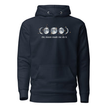 Load image into Gallery viewer, unisex navy blue hoodie with image phrase "The moon made me do it." With image graphic of watercolor moon phases, decorated with random gold star constellations. Front view.