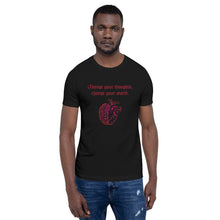 Load image into Gallery viewer, man modeling/wearing unisex black t-shirt, with image design: red half brain, half heart. Image phrase: Red text - Change your thoughts, change your world. Front view.